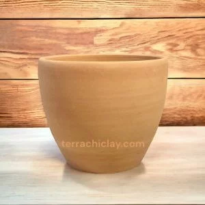 Home 4 Adorable clay pot displayed on a table, great for adding a rustic charm to any room.