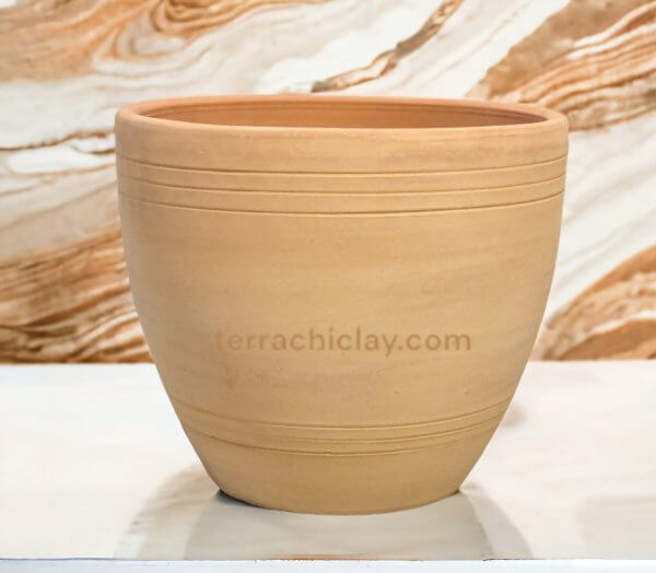 Clay planter on marble counter.