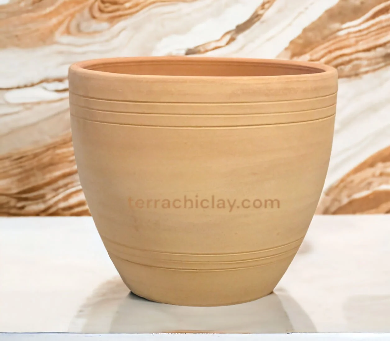 Clay planter on marble counter.
