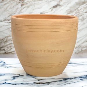 A large clay pot on a marble counter.