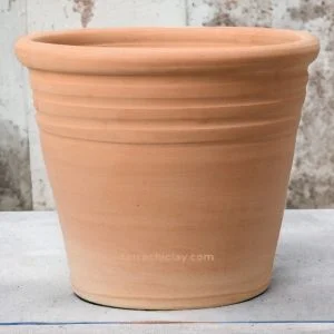 clay planter of conical shape on concrete floor