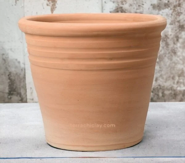 clay planter of conical shape on concrete floor