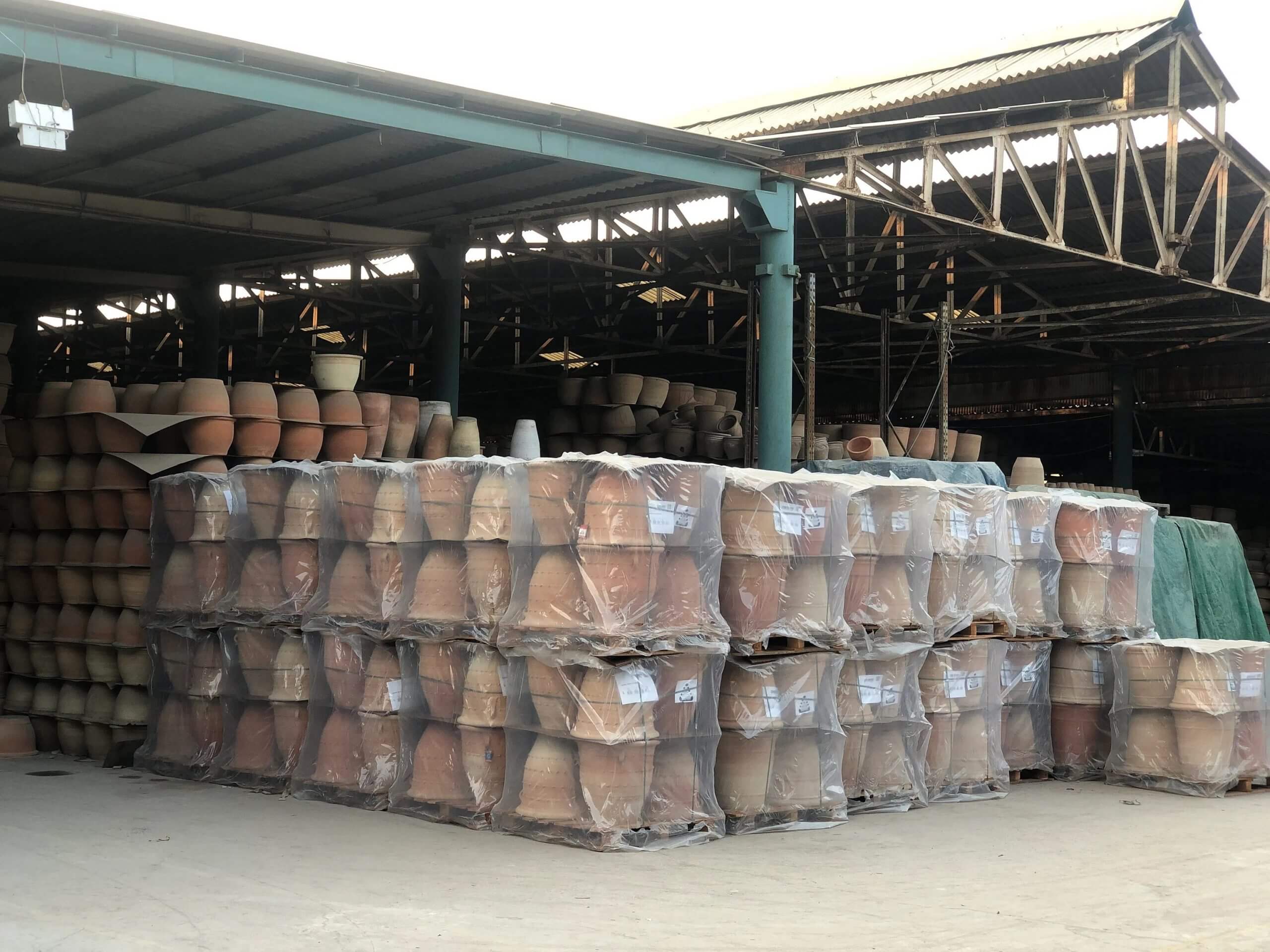 Home 6 Terrachi Clay manufacturing facility with stacked terracotta pots ready for export to USA