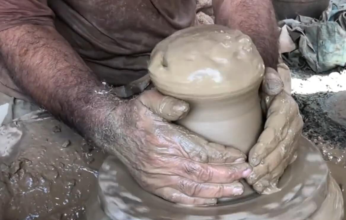 Skilled artisan throwing clay on a traditional wheel to create a handmade terracotta pot at Terrachi Clay