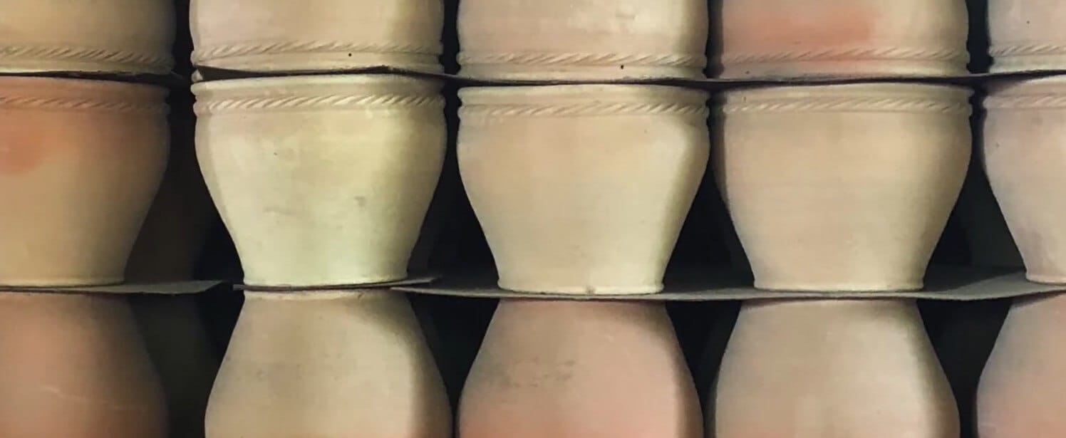 Freshly fired handmade terracotta pots cooling after removal from the kiln